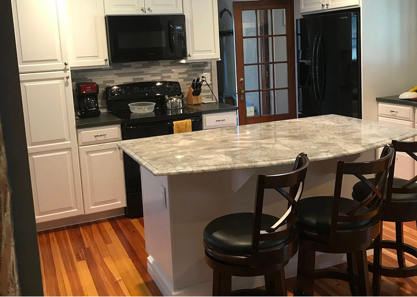 Modern kitchen with island and bar stools.
