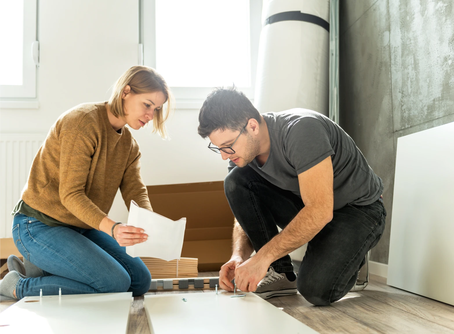 Couple assembling furniture together