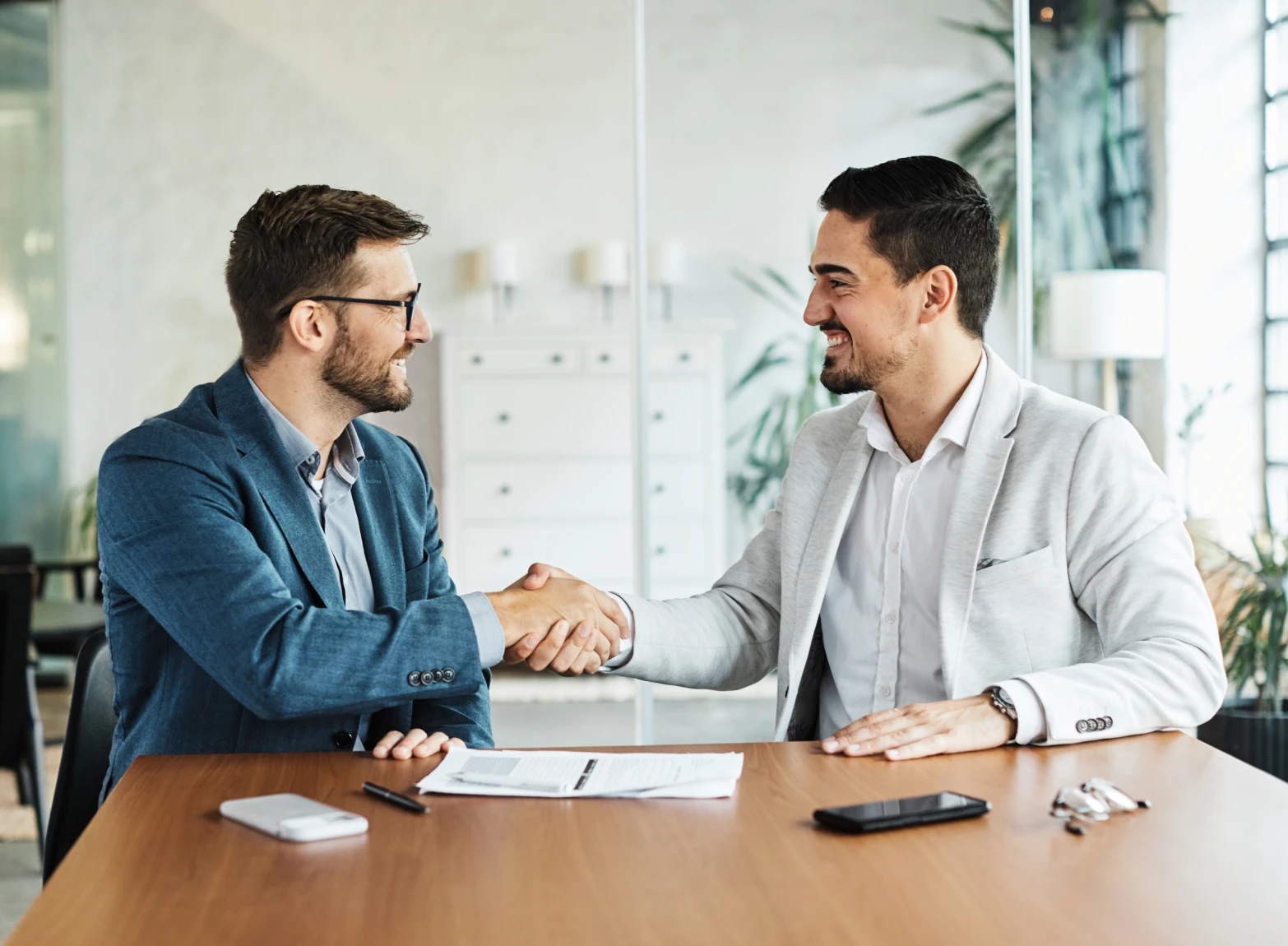 Business handshake in modern office setting.